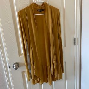 Vivian Shyu Light weight long sleeve cardigan with ruffle trim bottom.